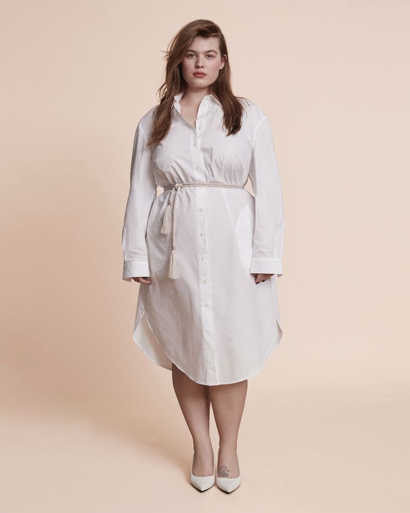 Front of a model wearing a plus size Amena Shirtdress in Optic White by 11 Honoré Collection. | dia_product_style_image_id:199927